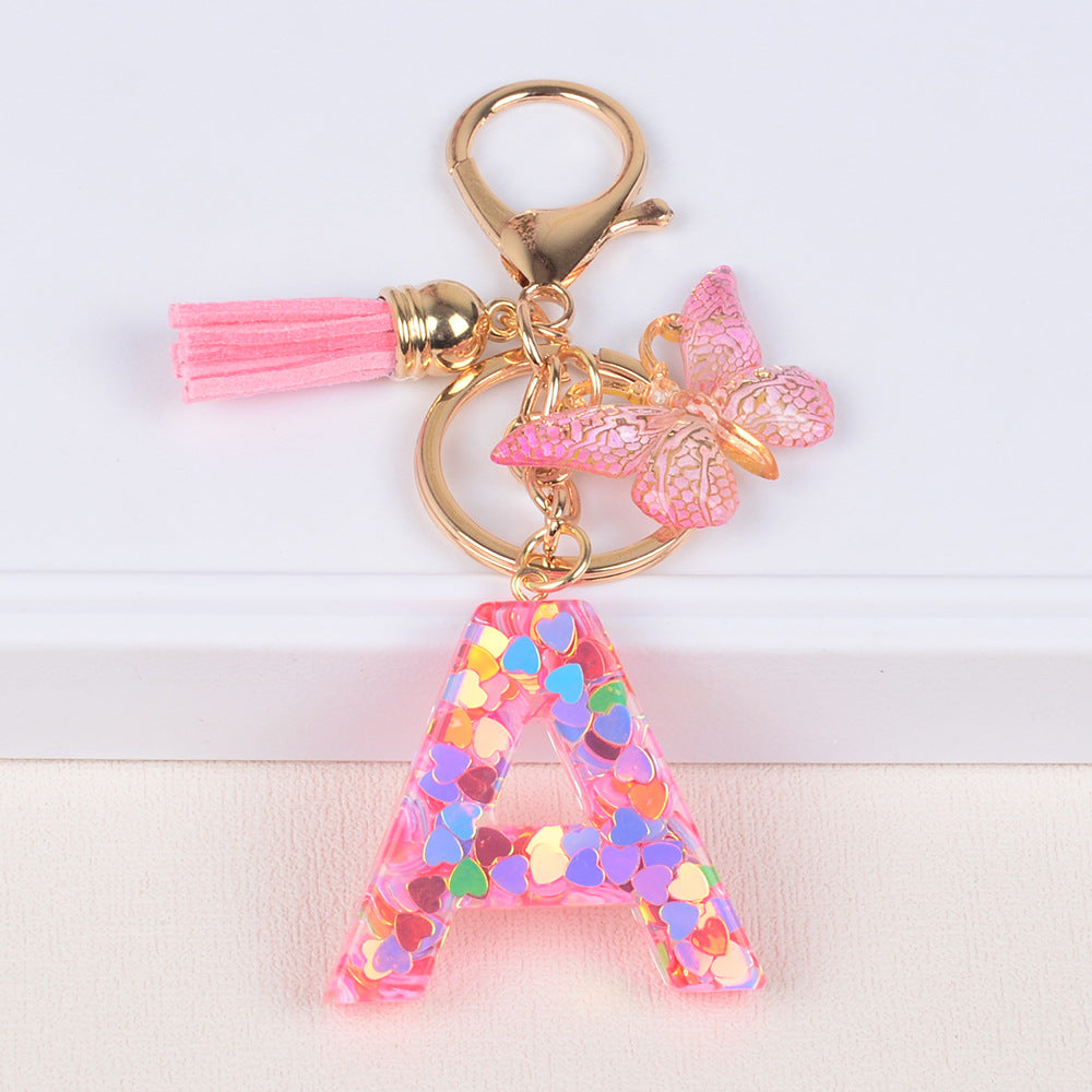 卸売ピンクタッセルバタフライグリッターレター樹脂キーホルダー